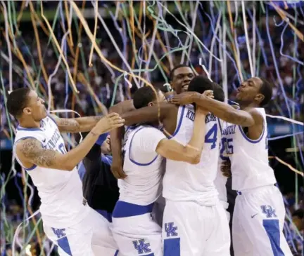  ?? ASSOCIATED PRESS FILE PHOTO ?? In this April 2, 2012, file photo, Kentucky players celebrate its national championsh­ip against Kansas. The Associated Press is ranking the top 100 college basketball programs of all time using 68 years of data from the AP Top 25 poll.