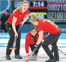  ??  ?? Eve Muirhead lays down a stone alongside Lauren Gray (left) and Vicki Adams.