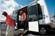  ??  ?? Test run: Elderly passengers getting off Robot Shuttle
in Nishikata. — Reuters