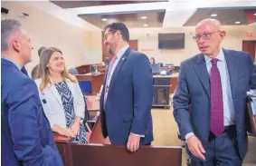  ?? EDDIE MOORE/JOURNAL ?? From left, Deputy Secretary of State John Blair, Secretary of State Maggie Toulouse Oliver and House Speaker Brian Egolf, D-Santa Fe, talk as Paul Kennedy, attorney for the Governor’s Office, leaves a 1st Judicial District courtroom Friday in Santa Fe.