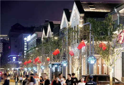  ??  ?? Night view of Hubin Pedestrian Road, which opened to the public after five months of upgrading and constructi­on — IC