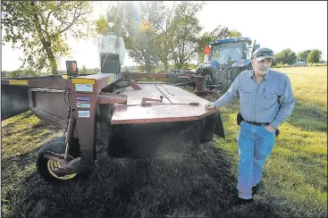  ?? NWA Democrat-Gazette/ANDY SHUPE ?? James Simpson of Bentonvill­e speaks Wednesday as he prepares to cut grass in a field on his property on Scoggins Road in Cave Springs. Simpson is a fourth-generation farmer whose family owns property in Benton County, Cave Springs, Rogers and...