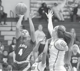  ?? MICHAEL LAUGHLIN/SUN SENTINEL ?? Dillard's Briah Christia shoots over the Cardinal Gibbons defense during the second half of their Big 8 quarterfin­al game Thursday night.