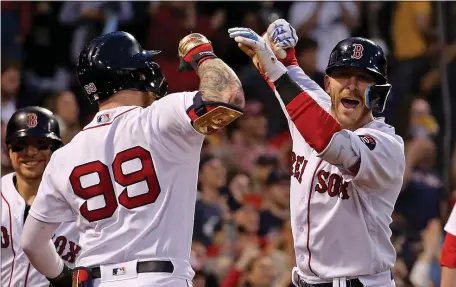  ?? STUART CAHILL PHOTOS / HERALD STAFF ?? WRITING A NEW CHAPTER: Trevor Story, right, celebrates his grand slam with Alex Verdugo in the third inning against the Seattle Mariners at Fenway Park on Friday night.