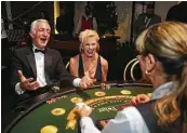  ?? Mark Mulligan / Houston Chronicle ?? Kevin O’Sullivan and Kristen Strubbs enjoy a game of blackjack during the Bulls & Blackjack event.