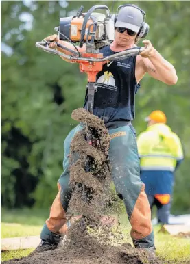  ?? Photo / Mike Scott ?? Dirt flies from Jayden Hart’s post-hole digger during a Fieldays contest at Mystery Creek.