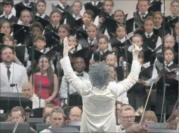  ?? Photograph­s by Lawrence K. Ho Los Angeles Times ?? THE NATIONAL Children’s Chorus, soloists and Philharmon­ic players face conductor Gustavo Dudamel.