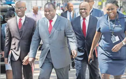  ??  ?? Contagion: Finance Minister Tito Mboweni (second from left) gave only a passing nod to activity on the internatio­nal scene and expecting growth from exports may be a little optimistic. Photo: Rodger Bosch/AFP