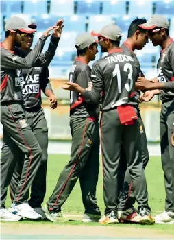  ?? — Supplied photo ?? UAE players celebrate a wicket during the semifinal against Qatar at the Dubai Internatio­nal Cricket Stadium on Wednesday.