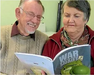  ?? PHOTO: BOBBIE NICHOLLS/SUPPLIED ?? Contributo­r Val Brannan, right, and husband Geoff read the second volume of War Stories, published by Literacy Feilding.