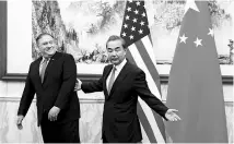  ?? PHOTO: REUTERS ?? US Secretary of State Mike Pompeo (left) with Chinese Foreign Minister Wang Yi before a meeting in Beijing on Monday