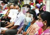  ?? PTI ?? People, wearing face mask, wait for their turn to receive the dose of Covid-19 vaccine at a government hospital, in Chennai