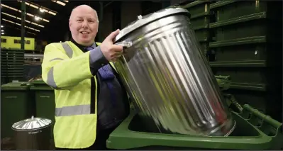  ??  ?? Councillor Kenny McLean, above, gets rid of an old bin into one of the new wheelie bins at Blochairn recycling facility