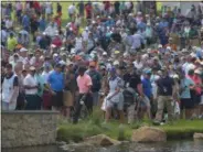  ?? PETE BANNAN — DIGITAL FIRST MEDIA ?? Tiger Woods and his entourage cross the bridge onto the 17th hole at Aronimink Golf Club Friday at the BMW Championsh­ip.