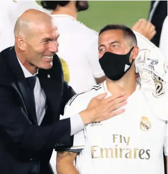  ??  ?? REAL Madrid’s coach Zinedine Zidane and Eden Hazard celebrate after winning La Liga on Thursday night when they beat Villarreal. | Reuters
