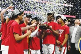  ?? AP PHOTO/JOHN AMIS ?? Alabama players pose with the Southeaste­rn Conference men’s basketball tournament trophy after beating Texas A&M on Sunday in Nashville. The Crimson Tide also won the regular-season title, completing an SEC sweep for the second time in three years