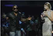  ?? THE ASSOCIATED PRESS ?? Singer Kanye West takes the microphone from singer Taylor Swift as she accepts the best female video award during the 2009MTV Video Music Awards.