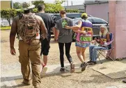  ?? ROGELIO V. SOLIS / AP ?? A patient is escorted into the Jackson Women’s Health Organizati­on clinic compound by security officers and clinic escorts, in Jackson, Miss., Tuesday.