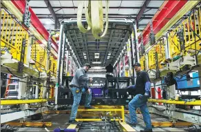  ?? YANG LEI / XINHUA ?? Workers man an assembly line at a BYD car manufactur­ing facility in Lancaster, California, in March. The Chinese automaker aims to take a 30 percent share of the electric bus market in North America.