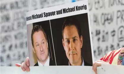  ??  ?? A photo of Canadians Michael Spavor (L) and Michael Kovrig, who have been detained in China. Photograph: Jason Redmond/AFP/Getty Images