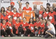  ?? The Canadian Press ?? Prime Minister Justin Trudeau attends a hockey event with Hayley Wickenheis­er, his 10-year-old son Xavier, and the Indian women's national ice hockey team in New Delhi, India on Saturday.