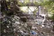  ?? MATT ROURKE - THE ASSOCIATED PRESS ?? This July 31, 2017, file photo, shows trash including discarded syringes and other rubbish in an open-air heroin market that has thrived for decades, before cleared away by the city, along train tracks a few miles outside the heart of Philadelph­ia....