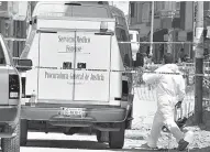  ??  ?? Especialis­tas del Servicio Médico Forense, el 12 de marzo luego de la masacre ocurrida en un hotel de Comonfort, con cinco víctimas.