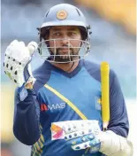  ?? — AFP ?? Sri Lanka’s Tillakarat­ne Dilshan walks with his equipment during a practice session at the R Premadasa Internatio­nal Cricket Stadium in Colombo.