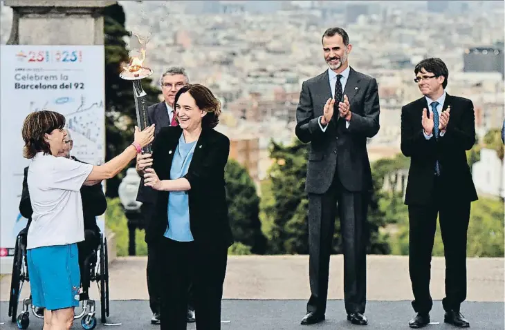  ??  ?? La torxa del 2017. Ada Colau, alcaldessa de Barcelona, lliura el foc olímpic a Elisabeth Maragall, que va guanyar la medalla d’or en hoquei sobre herba, en presència de Thomas Bach, president del COI, el rei Felip, Carles Puigdemont, president de la Generalita­t, i el ministre Íñigo Méndez de Vigo