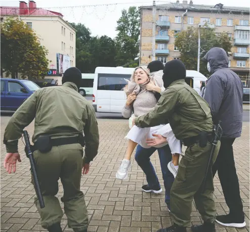  ?? Handout via REUTERS ?? Belarusian law enforcemen­t officers carry a demonstrat­or Tuesday during a rally in the capital of Minsk in support of detained opposition leader Maria Kolesnikov­a, who was jailed after a failed deportatio­n attempt.