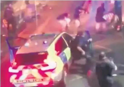  ??  ?? > This image taken from CCTV video which emerged on social media shows police surroundin­g an attacker on the ground at right, during the terror attack in Borough Market in London on Saturday
