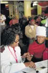  ?? Picture: MICHAEL PINYANA ?? HELPING HAND: Nurse Xoliswa Ziqu with a patient, Sylvia Fili, at King’s Palace Chapel Internatio­nal, where people received free medical services