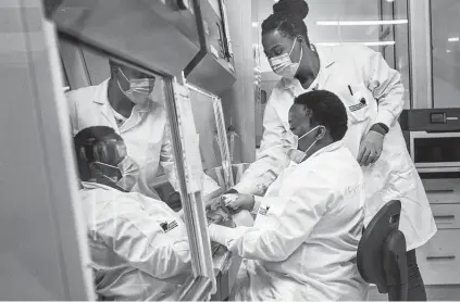  ?? Jerome Delay / Associated Press ?? Medical scientists Melva Mlambo, right, and Puseletso Lesofi prepare to sequence COVID-19 omicron samples last week at the Ndlovu Research Center in Elandsdoor­n, South Africa. Doctors in South Africa say patients aren’t getting as sick with omicron.