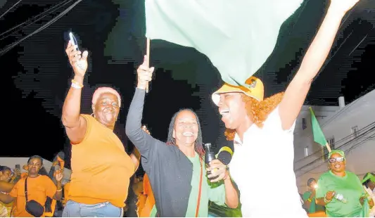  ?? ASHLEY ANGUIN/PHOTOGRAPH­ER ?? People’s National Party and Jamaica Labour Party supporters wait for the results for the local government elections on Westgreen main road in Montego Bay, St James.