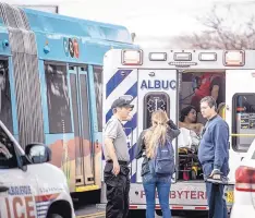  ?? ROBERTO E. ROSALES/ JOURNAL ?? A man is taken away in an ambulance after being hit by an ART bus Wednesday afternoon near UNM.