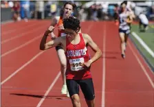  ?? PAUL CONNORS / BOSTON HERALD ?? FINISHING STRONG: Burlington’s Rithikh Prakash, front, pumps his fist in celebratio­n as he wins the 2-mile at the MSTCA Coaches Invitation­al at BC High on Saturday.