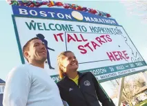  ?? STEW MILNE / ASSOCIATED PRESS ?? Jonathon Hawkins, left, and Beth Millian, right, both from Austin, Texas, pose for a photo by the Boston Marathon start sign prior to the 115th running of the Boston Marathon in Hopkinton, Mass., in April 2011.