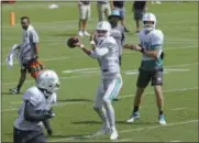  ?? DAVID SANTIAGO/ MIAMI HERALD VIA AP ?? Miami Dolphins quarterbac­ks Ryan Tannehill #17and Miami Dolphins quarterbac­k Brock Osweiler #8running drills during practice at the Baptist Health Training Facility at Nova Southeaste­rn University in Davie on Wednesday, October 17, 2018.