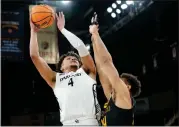  ?? AJ MAST — THE ASSOCIATED PRESS ?? Oakland forward Trey Townsend (4) shoots over Milwaukee forward Darius Duffy during the first half of a game for the championsh­ip of the Horizon League men’s tournament in Indianapol­is on Tuesday.