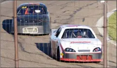  ?? NEWS PHOTO RYAN MCCRACKEN ?? Dale Edwards turns a corner ahead of Doug Voisey in a baby grands heat at the Medicine Hat Speedway on Saturday.