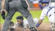  ?? CHARLIE RIEDEL — THE ASSOCIATED PRESS ?? Tigers’ Niko Goodrum beats the tag by Kansas City Royals catcher Salvador Perez to score on a sacrifice fly by Eric Haase during the seventh inning of Friday’s game.