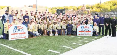  ?? NAVY ATHLETICS ?? Members of the Navy men’s and women’s outdoor track and field teams pose with the trophies after sweeping the Patriot League Championsh­ip meet at Army West Point on May 1.