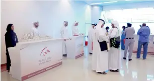  ??  ?? The first delegation of pilgrims travelling for the Haj at Sharjah Airport and, right, pilgrims get last-minute check-ups done at the the DHA counter at Terminal 3 in Dubai.