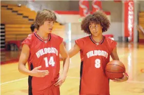  ?? FRED HAYES/DISNEY/TNS ?? Zac Efron and Corbin Bleu in “High School Musical.”