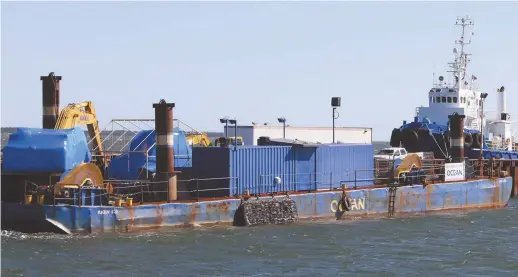  ?? - Acadie Nouvelle: Réal Fradette ?? Groupe Océan a deux navires-remorques, une barge et des camions au quai de Caraquet.