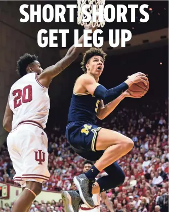  ?? MARC LEBRYK, USA TODAY SPORTS ?? Michigan’s D.J. Wilson, right, says the shorter shorts trend is on an upward trajectory.