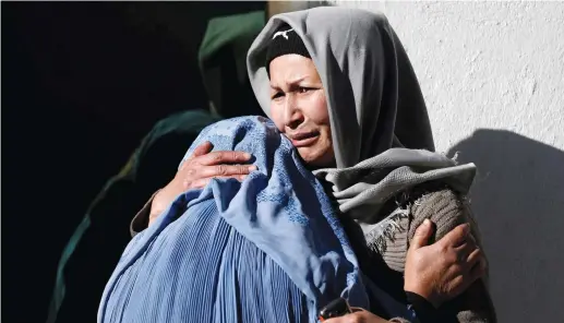  ?? (Mohammad Ismail/Reuters) ?? AFGHAN WOMEN mourn inside a hospital compound after a suicide attack in Kabul yesterday.