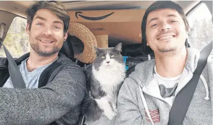  ?? CONTRIBUTE­D ?? Michael Martel, left, Screebie the cat and Will Carvalho sit tight on their trip from Edmonton to P.E.I. in early May.