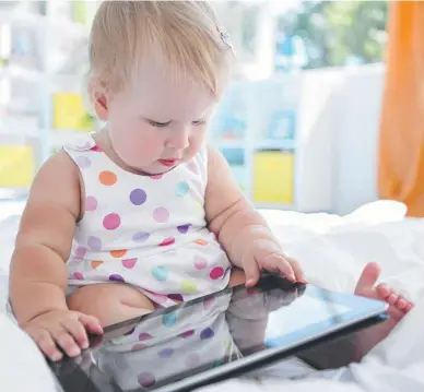  ??  ?? SCREEN TIME: Little ones are often distracted or pacified by devices like the iPad.