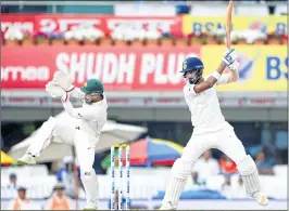  ??  ?? Lokesh Rahul (R) plays a shot past Australian wicketkeep­er Matthew Wade during the second day of play at the JSCA Stadium in Ranchi on Friday.